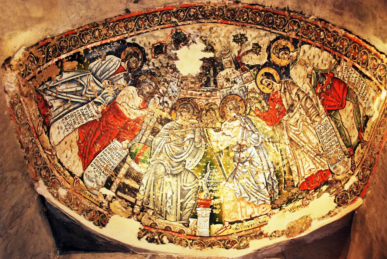 Painted saints and angels filling the half-dome of a monastery apse, the plaster cracked with age.