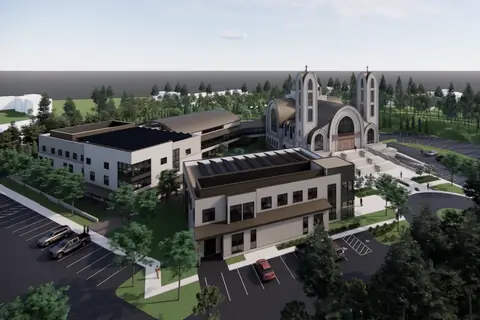 An aerial rendering of the whole site from the south-west, showing all three buildings, the piazza and the parking.