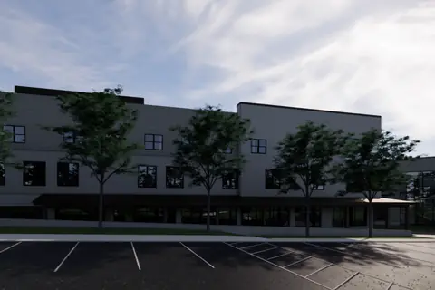 A rendering of the far end of the youth centre building across the car park, with the church dome visible beyond it.