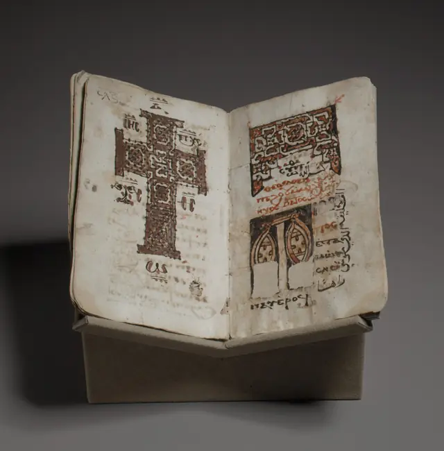 An illustrated page from a Coptic liturgical manuscript, with decorated initials.