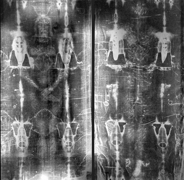 The photographic negative of the Shroud of Turin, showing the faint front and back of a man.