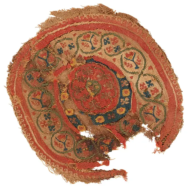 A fragment of woven Coptic textile with a geometric figured panel in dark thread.