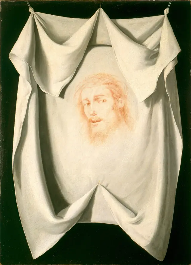 A painting of a white cloth pinned flat, the faint face of Christ visible on it.